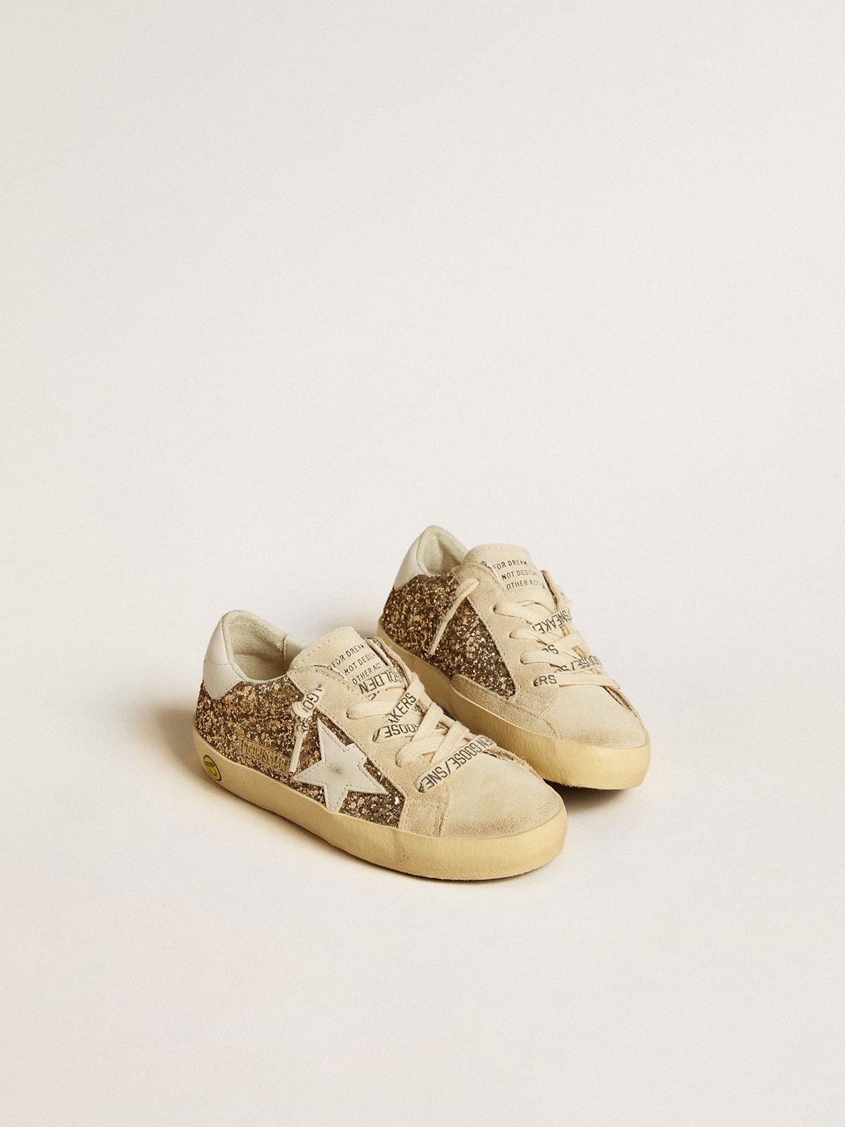 Super-Star Junior in gold glitter with white leather star and heel tab| Golden Goose